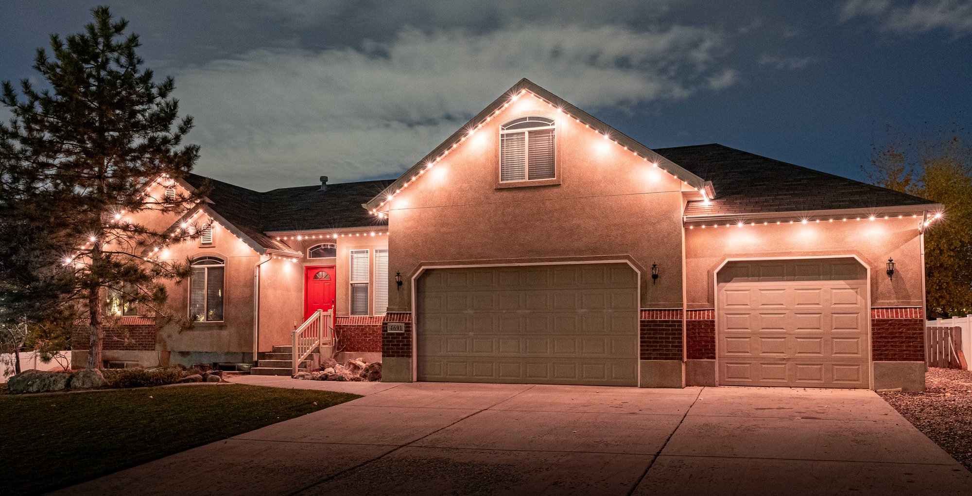 Residential home in Mid Michigan with permanent roofline lighting glowing warm white